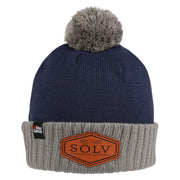 Abu Garcia Sölv Beany with a navy blue top, light-coloured turn-up, pom-pom and Sölv logo at the front.